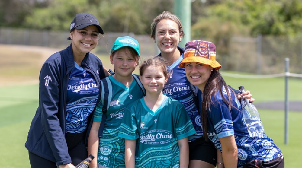 Two young people and three supervisors in Deadly Choices shirts.