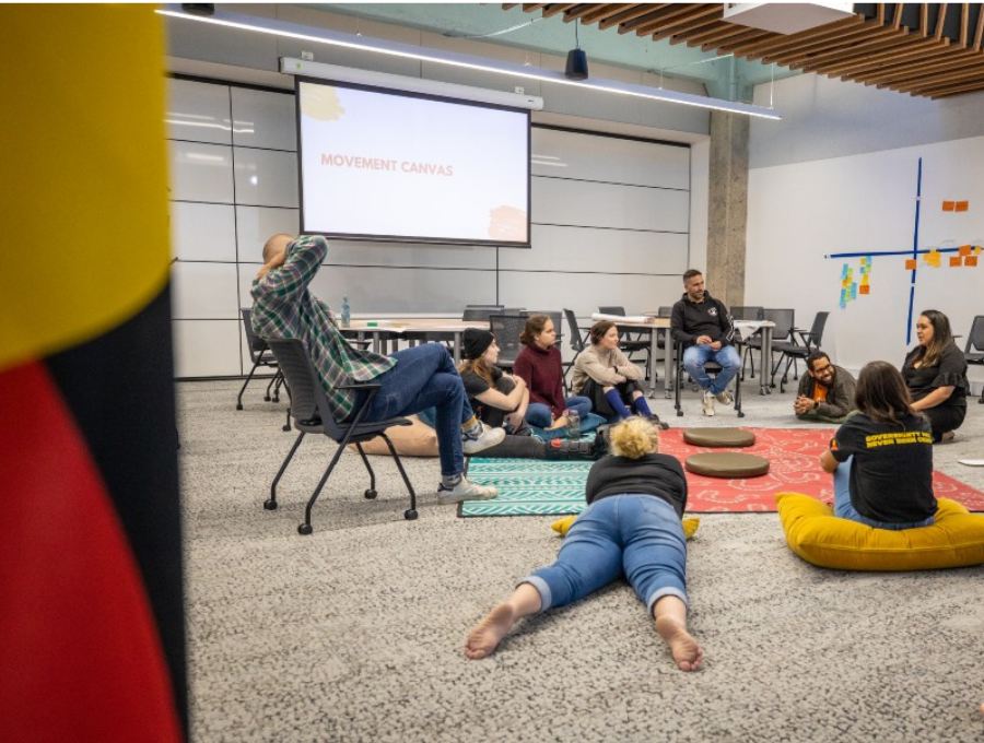 A group of people sitting in a circle having a discussion.