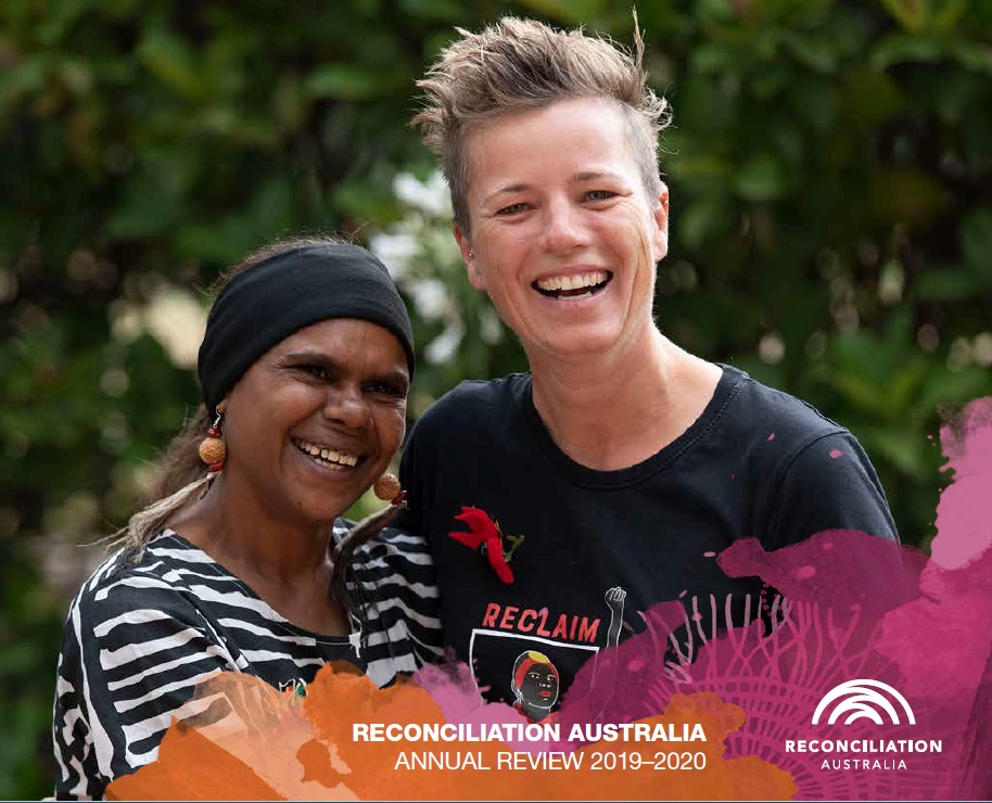 Cover of Reconciliation Australia Annual Review 2018-2019. Image shows a tall woman with short hair looking at the camera and embracing a shorter woman, who is smiling off to th