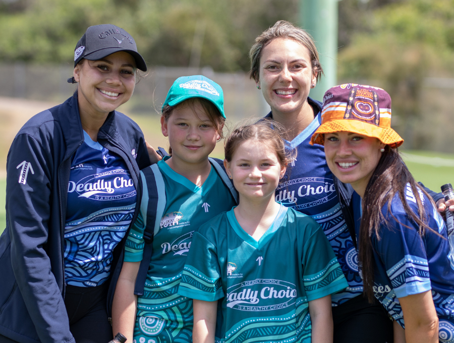 Two young people and three supervisors in Deadly Choices shirts.