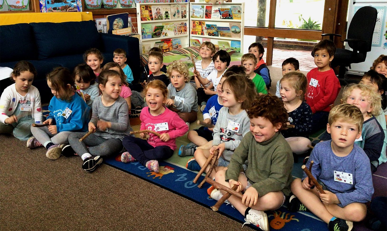 A group of school children sitting together at pre-school.