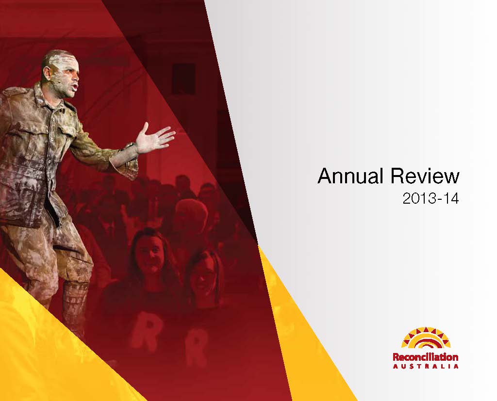 Cover of the Annual Review 2013-2014. Image shows a man in white paint, wearing what appears to be military uniform, performing to a group of people.