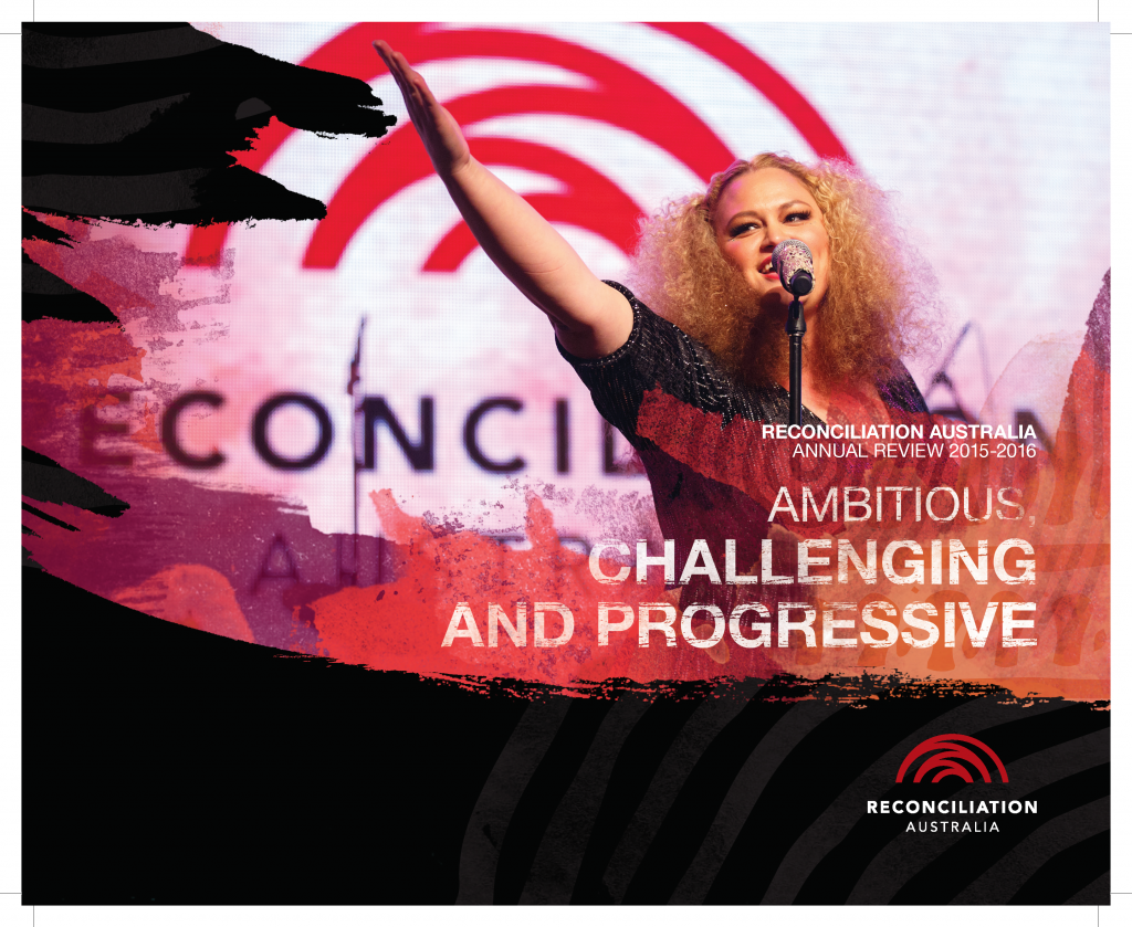 Cover of the Annual Review 2015-2016, image shows a woman on stage behind a microphone with her arm up, gesturing towards something in the crowd.