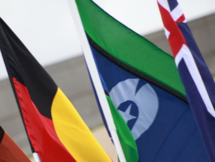 Image of Australian, Aboriginal and Torres Strait Islander flags flying together.