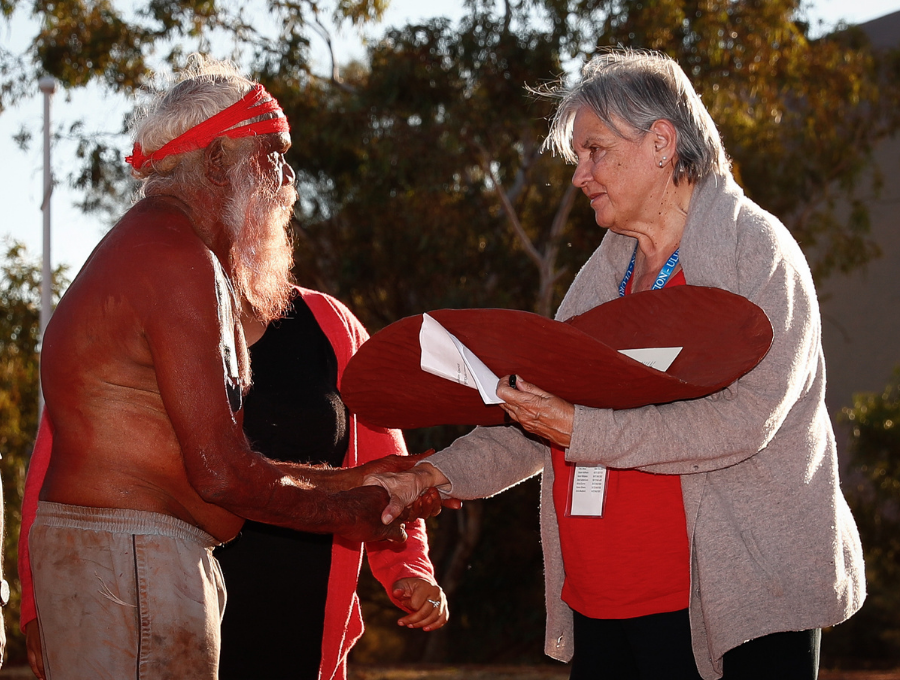 Image of Ms. Pat Anderson shaking hands with Traditional Owner.
