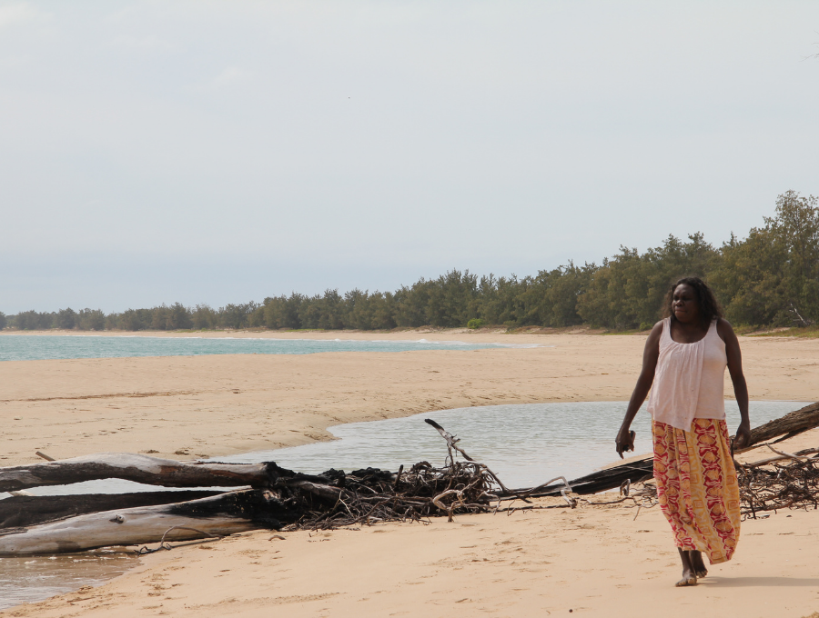 Woman walking along beach at 2013 Garma Festival