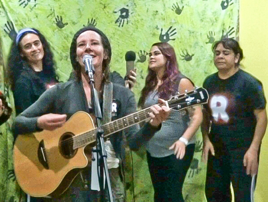 Kylie Kain sings singing Stompin The Ground with bandmates during Sing Loud competition