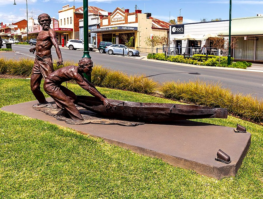 Bronze sculpture of two men and a canoe on the main street of Gundagai, NSW