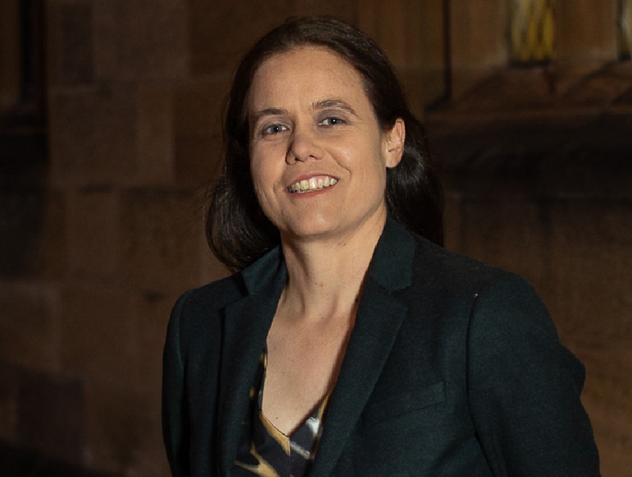 Dark haired woman in dress and blazer