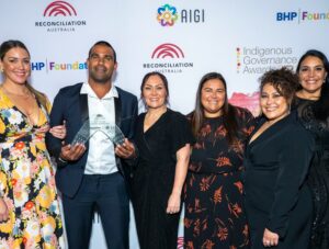 Representatives from Representatives from Naru Goori Groms pose for a photo with their award.