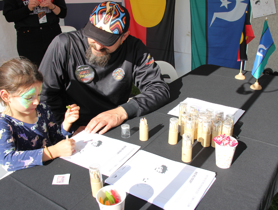 Families taking part in at activities at the combined Reconciliation Australia and Reconciliation Victoria stall at the Long Walk 2023 in Melbourne.