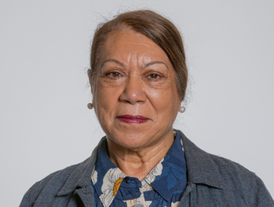 Shirley McPherson standing in front of a grey background.