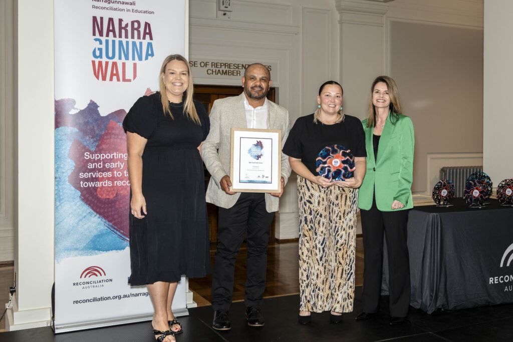Representatives from the winning school, Briar Road Public School, accepting their trophy and certificate at the Narragunnawali Awards ceremony.