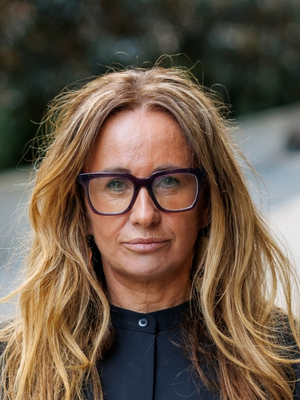 A woman looks down the camera.