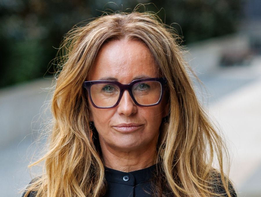 A woman looks down the camera.