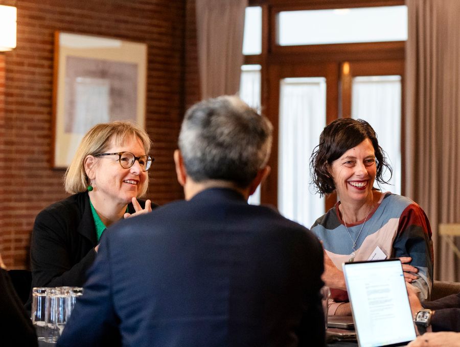A group of people sit around a table.